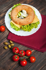 wholemeal bagel with green pesto, fresh vegetables, cheese, tomato and pear