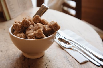 Bowl with brown sugar and silverwear