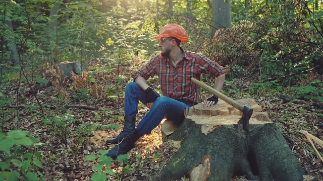 Lumberjack or logger sitting on a tree stump