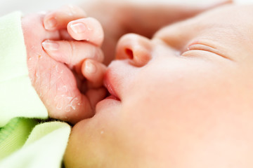 Obraz na płótnie Canvas CloseUp photo of cute newborn face part