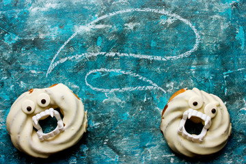Halloween donuts in white chocolate with teeth and eyes