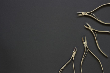 Manicure and pedicure cuticle nippers on the dark background