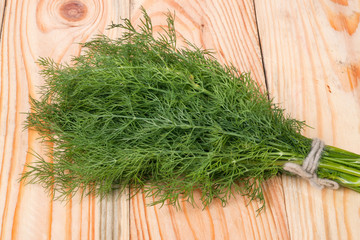bunch of dill on wooden background