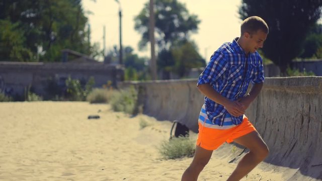Athlete man doing domestic gainer on the beach