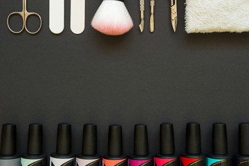 Manicure tools and polish on the dark background
