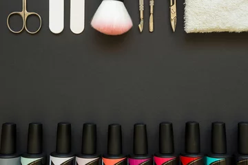 Foto op Canvas Manicure tools and polish on the dark background © fedorovacz