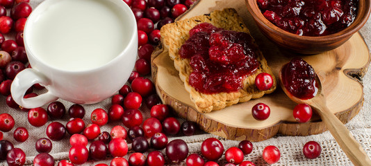 Breakfast with cranberries. Jam, cookies and milk.
