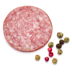 Salami smoked sausage one slice and peppercorns isolated on whit