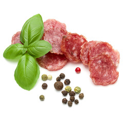 Salami smoked sausage slices, basil leaves and peppercorns isola