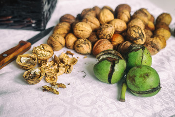 Walnuts and a knife on a whit background. Vintage style. selective focus. Concept of healthy food to health.