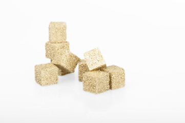 sugar cubes covered with gold on a white background