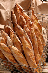 Traditional French baguette in a metal basket