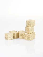 sugar cubes covered with gold on a white background