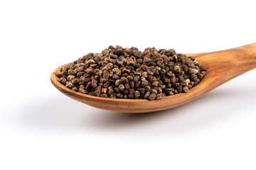 Decorticated cardamom seeds in a wooden spoon