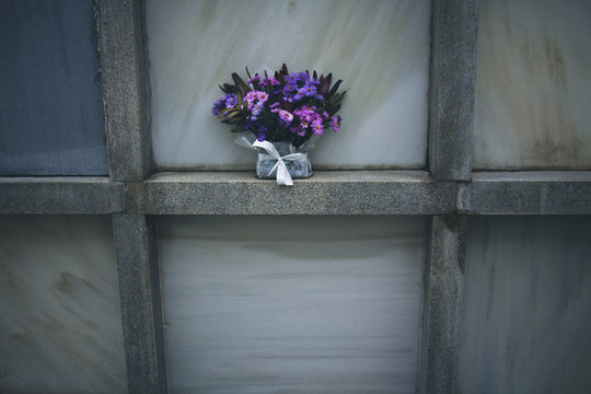grave in the cemetery with flower bouquet