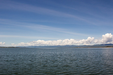 Fototapeta na wymiar lake water and mountain with blue sky