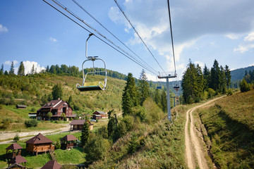 Lift in the Carpathians with green spruce trees in Summer