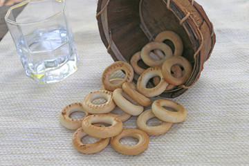 bagels in a basket with empty dishes on the table