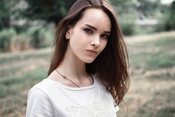 Naklejka premium portrait of a beautiful girl closeup on street