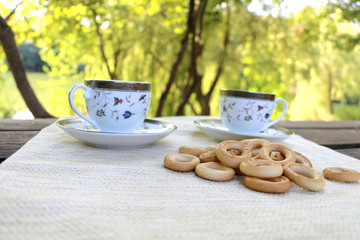 in nature, on the table bagels and cups,