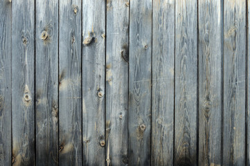 Background from old boards with knots and scratches. traces of the influence of weather. partially tinted photo.