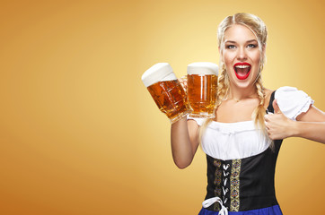 Young sexy Oktoberfest waitress, wearing a traditional Bavarian dress, serving big beer mugs on...