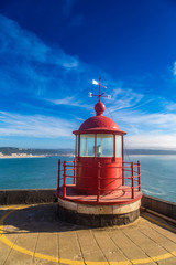 Closeup of a lighthouse lamp room on blue sky background in Nazare, Portugal © beketoff