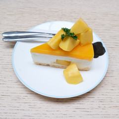 Mango cheesecake on white plate