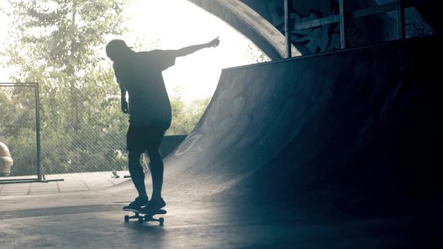 Skateboarder on skate doing flip tricks HD video slow motion on ramp skateboard park. Urban extreme sport lifestyle
