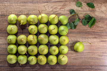 Fruit background. Fresh organic pears pattern with green leaves on old wood. Pear autumn harvest