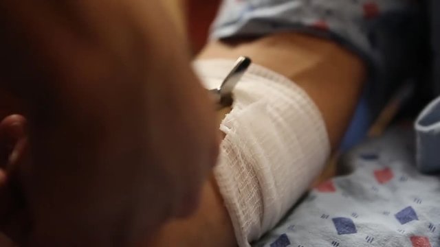 Nurse Cutting Bandage off of Patient's Arm