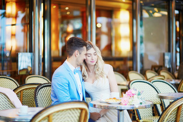 Just married couple in traditional Parisian cafe