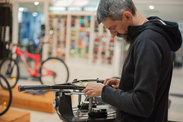 Stringing Machine. Tennis stringer doing racket stringing in his workshop