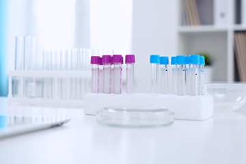 Research laboratory working space. Test tubes and tablet PC are lying at the table. Medical equipment. Blood test