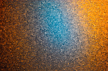 Slice of polystyrene on a gleam. Colorful self-illumination background