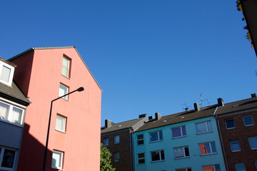 Fototapeta na wymiar Row of houses against a blue sky in Aachen, Germany