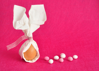 An egg tied in a serviette that looks like bunny ears for easter