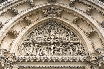 Obraz premium Bas-relief carved in stone above the entrance to the Catholic Ca