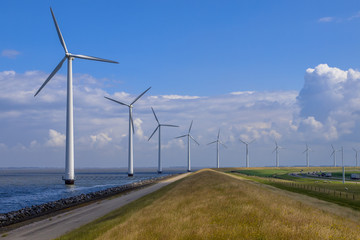 Row of windturbines along a dike