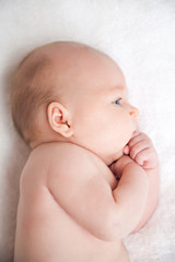 Close-Up Of A Baby Boy Lying On The Bed