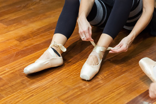 Ballerina putting on pointes