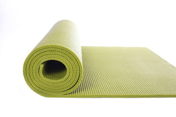 green yoga mat isolated on white background