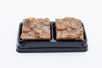 Walnut toffee cake isolated on white background