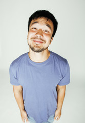 young cute asian man on white background gesturing emotional, pointing, smiling, lifestyle people concept