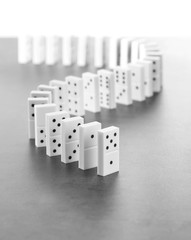 Dominoes standing on gray background