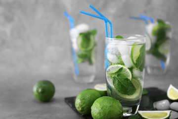 Cold fresh cocktails with lime on table