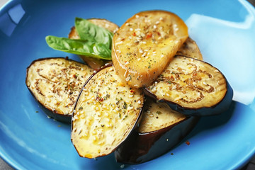 Baked eggplant on blue plate, closeup