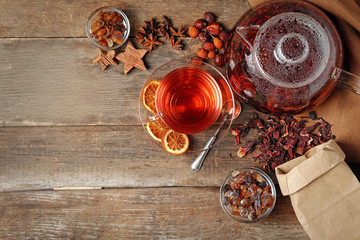 Ingredients for tea drinking on wooden background, flat lay
