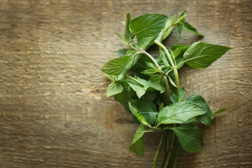 Bunch of fresh mint on wooden background, top view