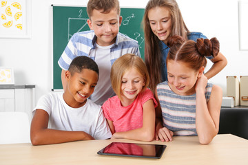 Fototapeta na wymiar Schoolchildren with tablet computer in classroom